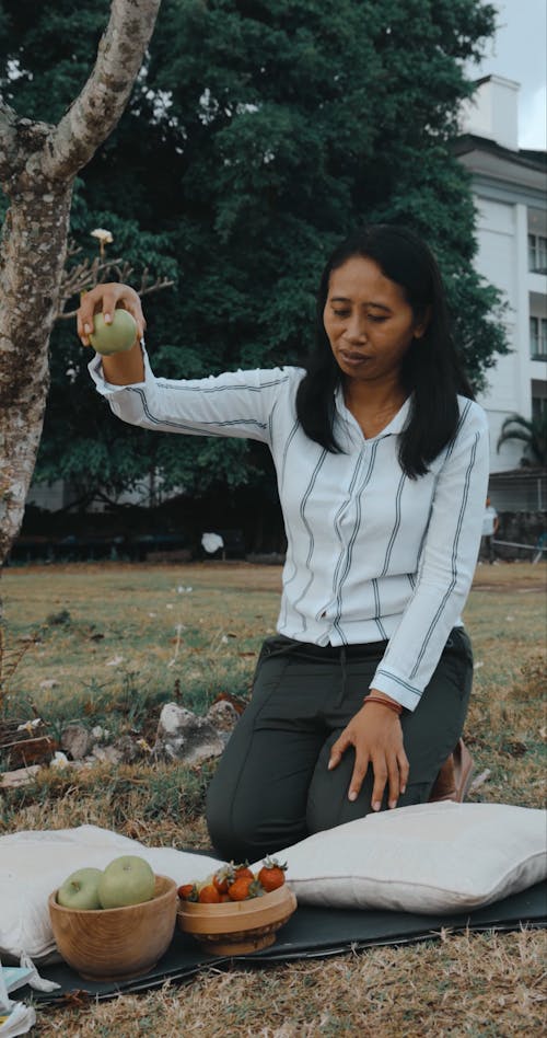 Woman Dropping Apple on Ground