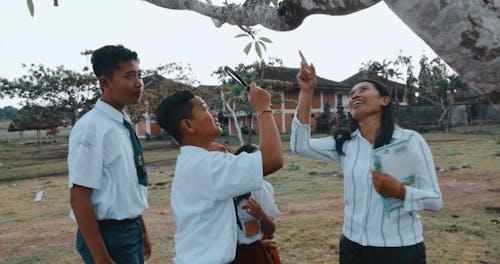 Teacher and Children on a Field Trip Looking at a Tree