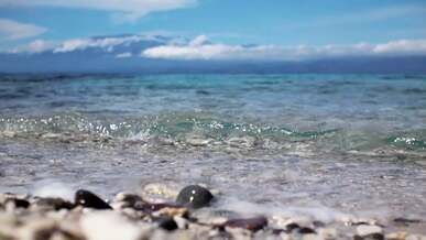 waves over stones on beach
