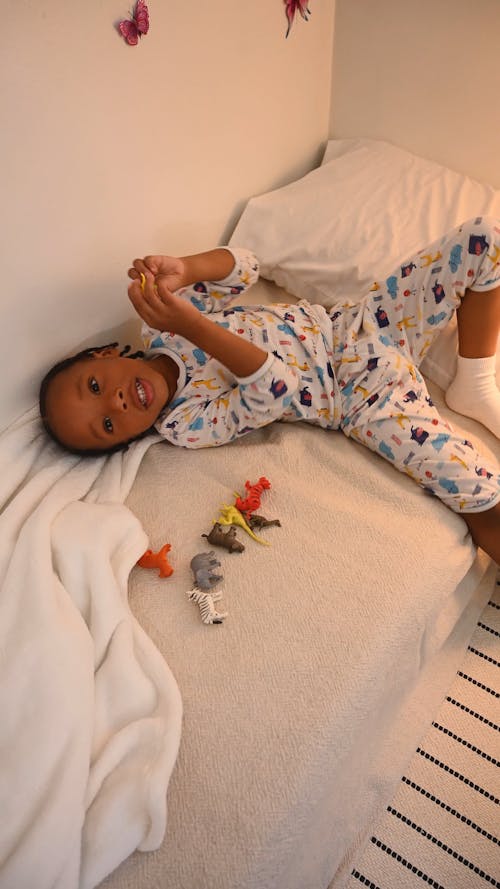 Boy Playing with Toys at Bedtime