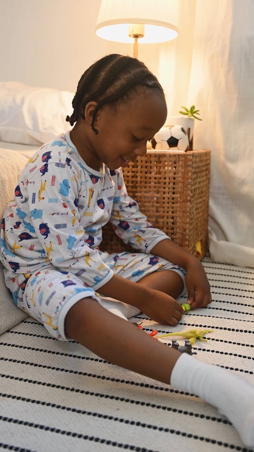 Boy Playing with Toys in his Bedroom