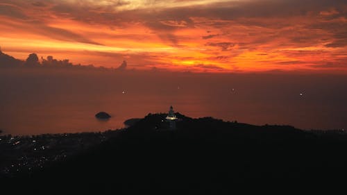 Drone View of the Great Buddha of Phuket under a Dramatic Orange Sky