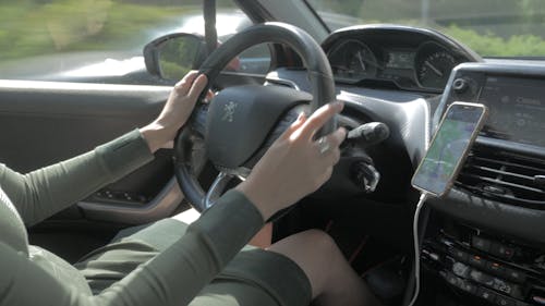 Hands of a Woman Driving a Car