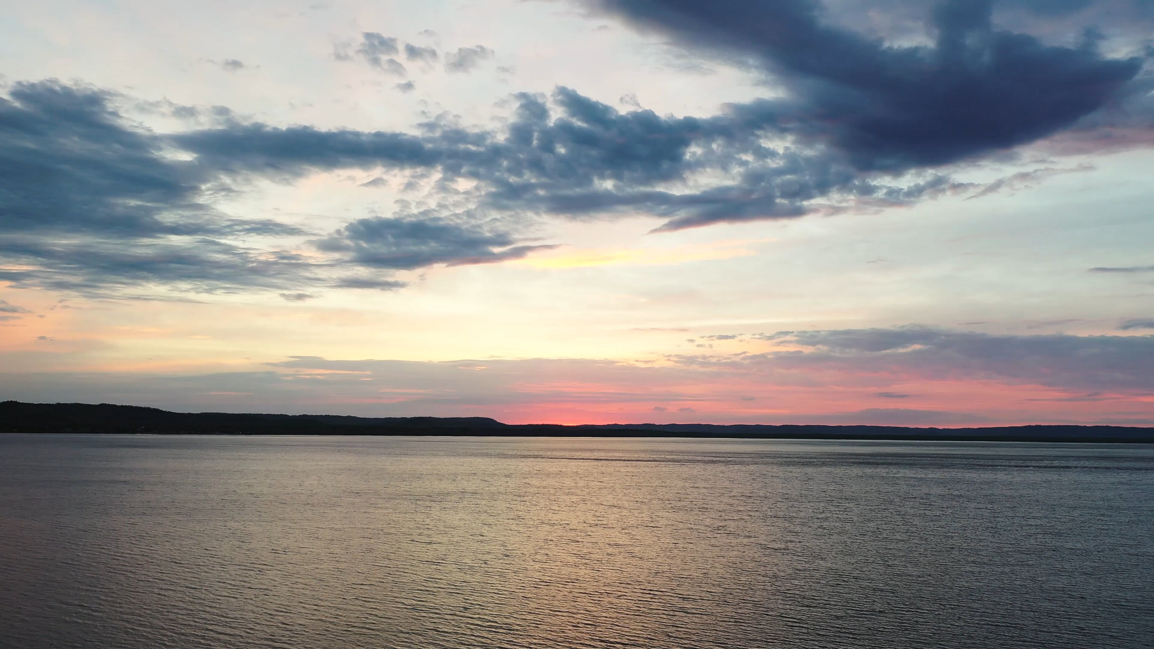 drone shot of vast water at sunset 12784303