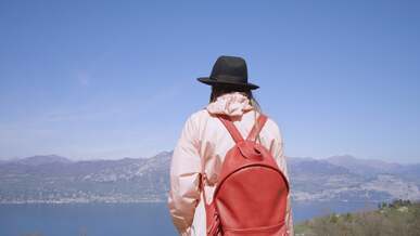 back view of a woman admiring a landscape