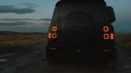 A Black SUV Parked on a Road 