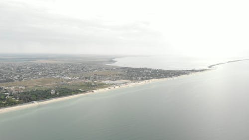Aerial View of a Coastal City with Sandy Beaches 