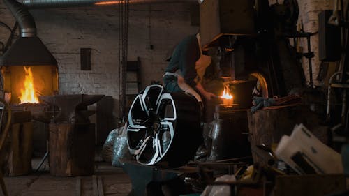 A Blacksmith Using a Power Hammer Machine at Work