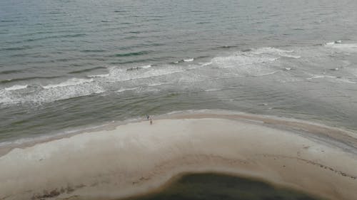 Drone View of Two People on the Beach