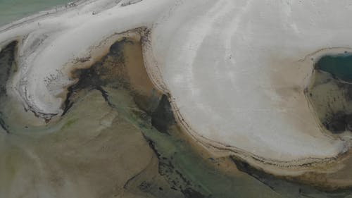 Aerial View of a Sandy Beach with Black Streaks 