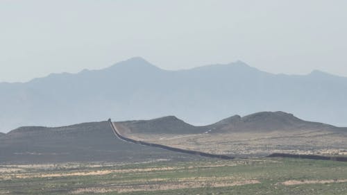 Scenery with Desert with a Wall and Mountains