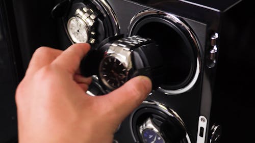 Hand Placing Clocks in Rolling Machine