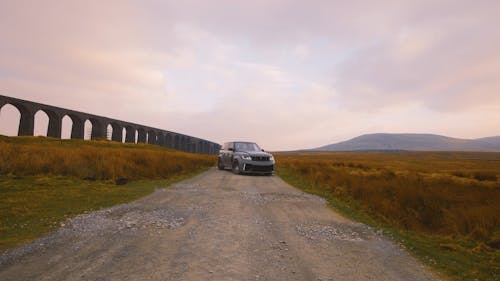 An SUV Parked on a Dirt Road