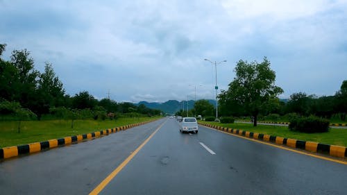 Driving along an Expressway under a Cloudy Sky 