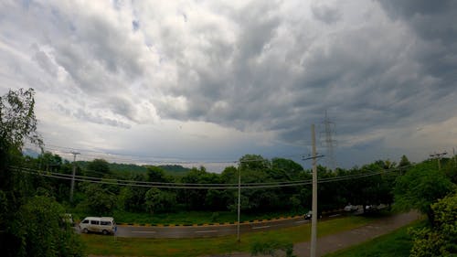 Time Lapse of Storm Clouds over a Busy Road 