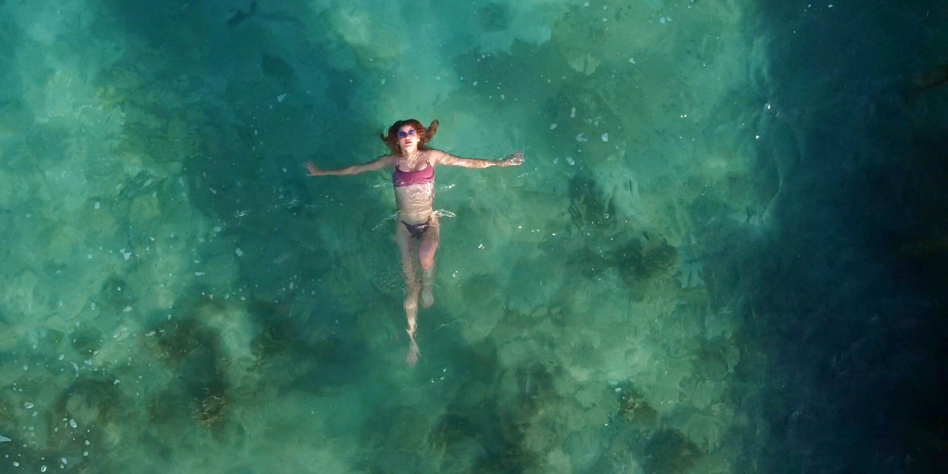 Aerial View of Woman Floating in Clear Water Free Stock Video Footage ...