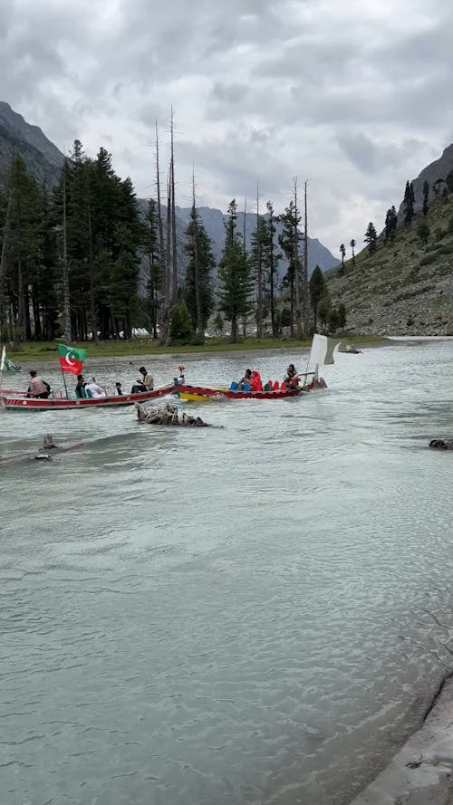 People with Flags on Motorboats