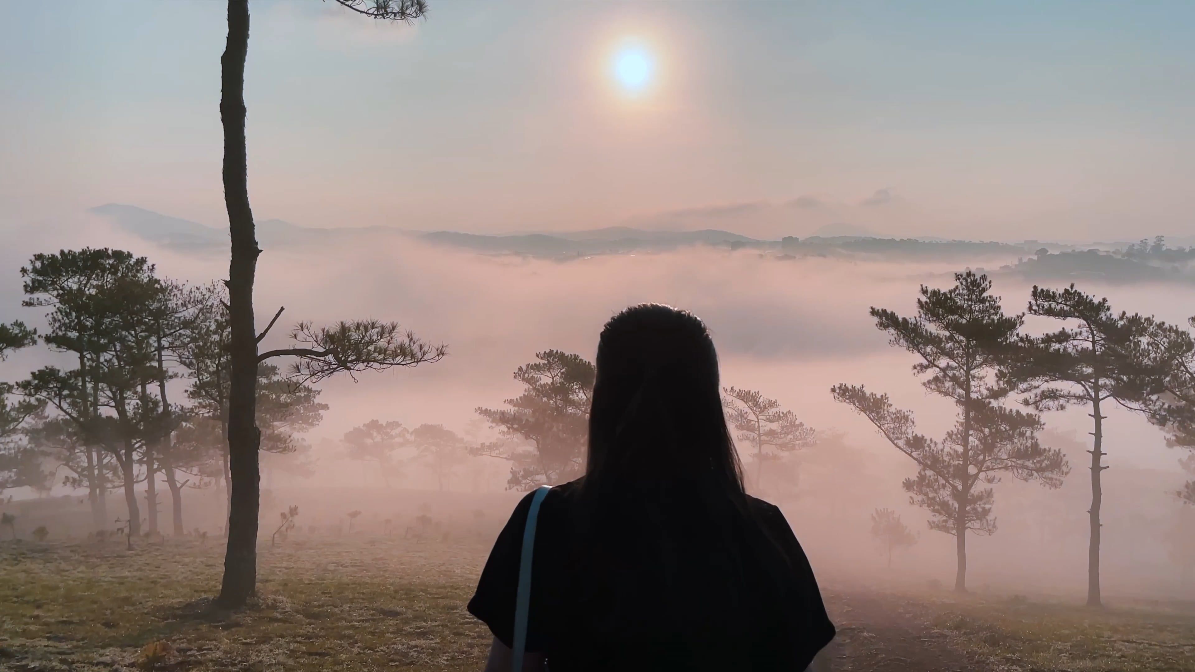 Back View of a Woman Walking in a Misty Mountain Landscape Free Stock ...