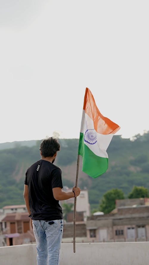 waving the flag of India in hand