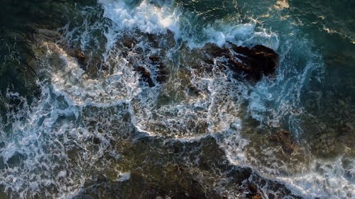 Top View of Breaking Waves on a Rocky Shore 