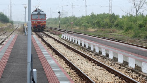 A Train Arriving at the Station in a Rural Area 
