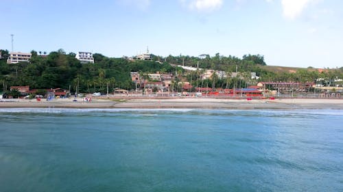 Drone Footage of a Tropical Beach and a Coastal Town 