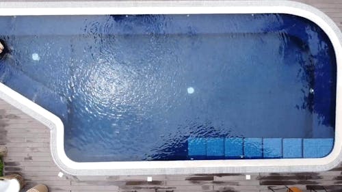 Overhead View of Man Swimming in Hotel Pool