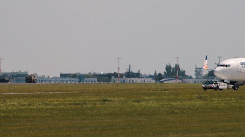 A Plane Being Towed along the Runway 