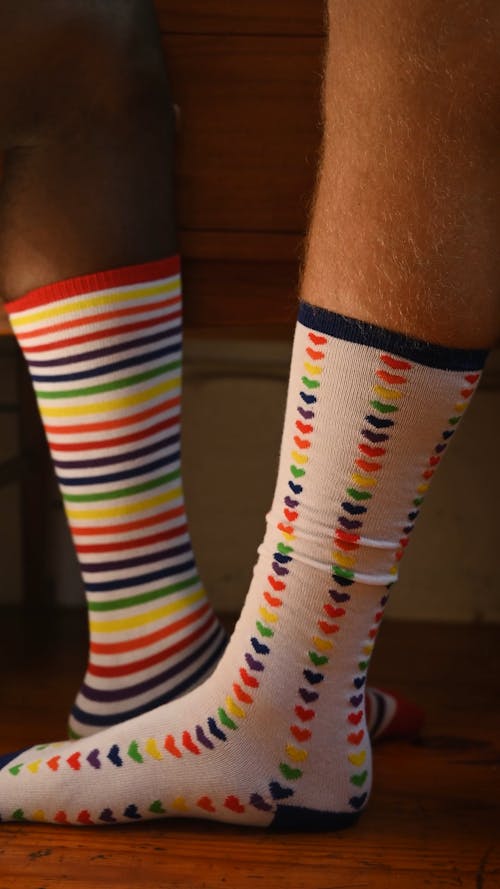 Close up of Two People Wearing Colorful Socks