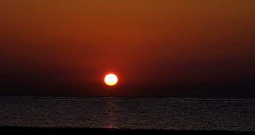 The Sun Rising over the Ocean