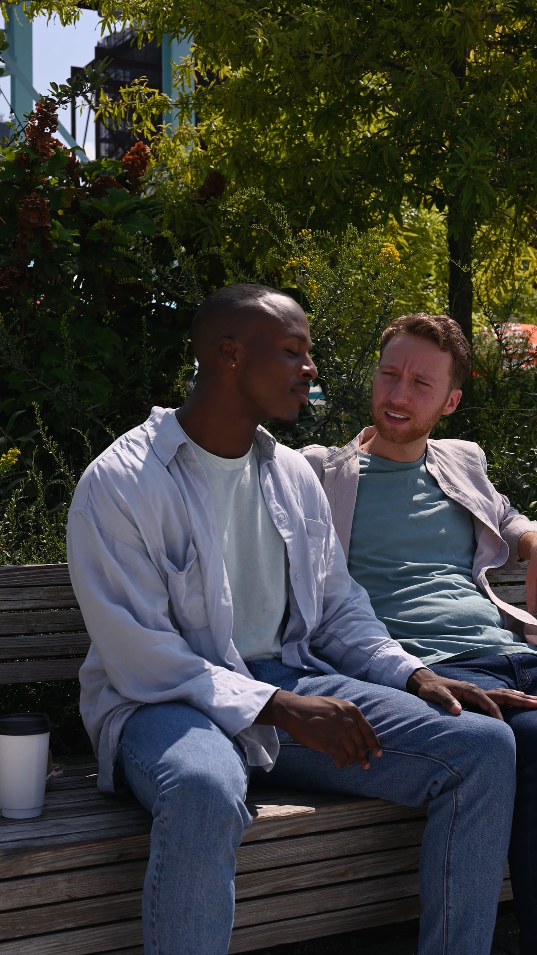Two Men Sitting on a Park Bench Talking and Laughing Free Stock Video ...
