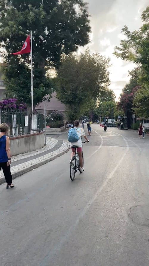 Back View of a Woman Riding a Bike in the Street 