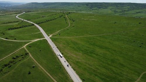 Drone Footage of a Country Road and Green Fields
