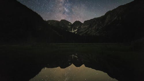 Stars in Night Sky over Mountain Lake