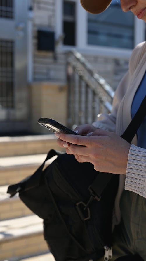 Close up View of a Woman Texting in the Street