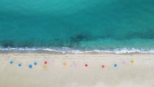 Top View of Colorful Parasols on a Sandy Beach 