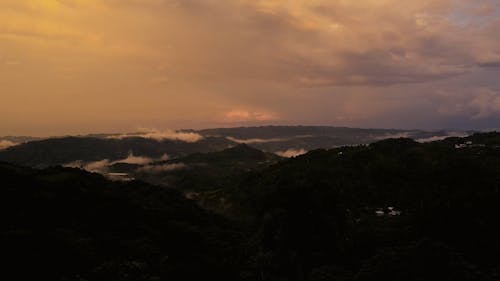 Drone Video of Green Mountains under a Sunrise Sky