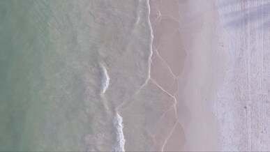 waves on beach in overhead view