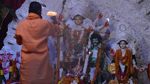 Man with Fire in Hand in Front of Altar