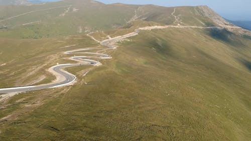 Cars on Curvy Road on Hill