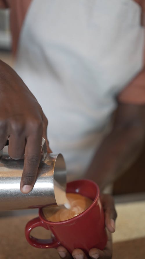 Close up of a Person Making Latte Art 