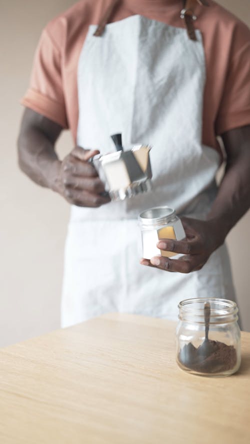 A Barista Making Coffee with a Moka Pot 