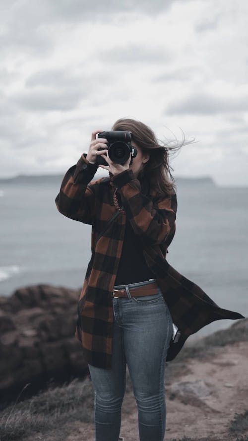 Woman in Coat Taking Photo