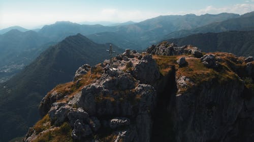 Drone Video of a Man Sitting by the Cross on the Top of Monte Grona, Italy