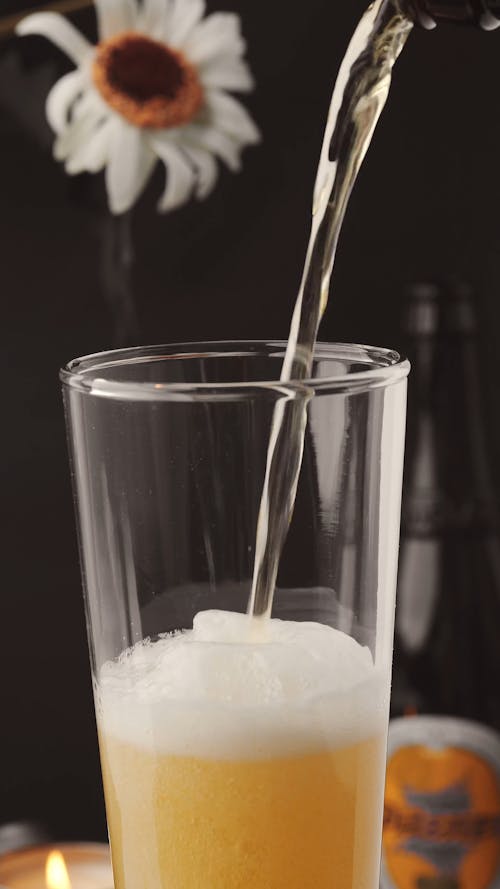 Beer Foam Pouring out of Glass