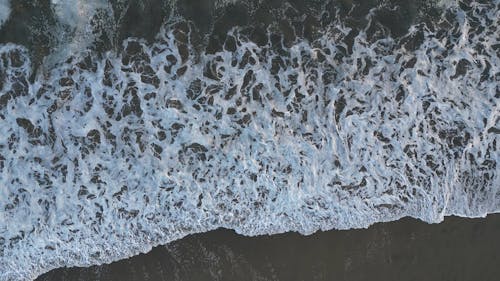 Top View of Sea Waves Breaking on the Shore 