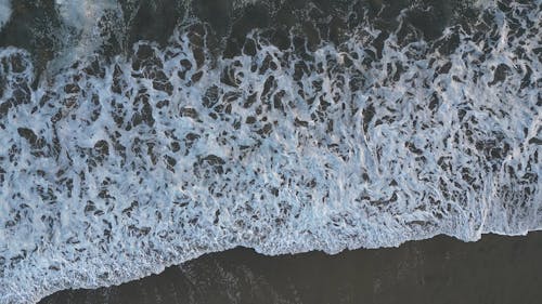 Top View of Sea Waves Breaking on the Shore 