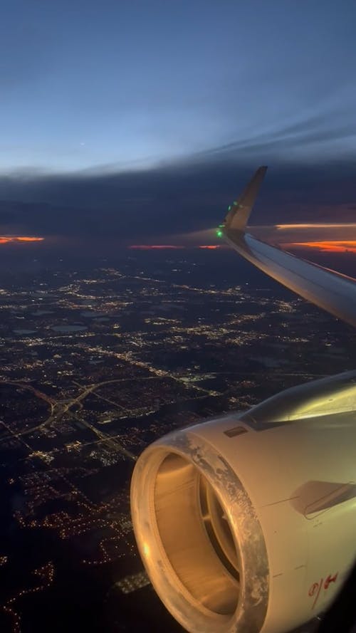 Window View from a Plane Flying over a City 