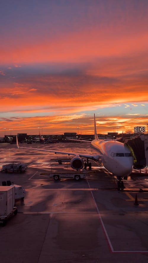 Planes Waiting on Airport Tarmac at Sunset