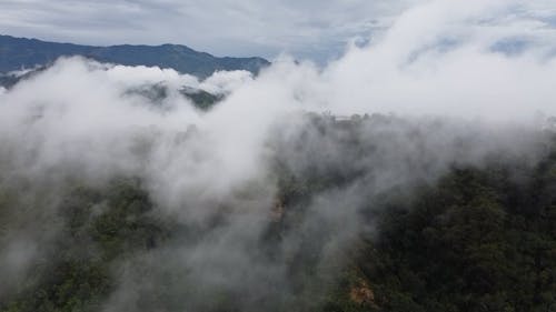 Drone Footage of Mountain Peaks Shrouded in a Thick Fog